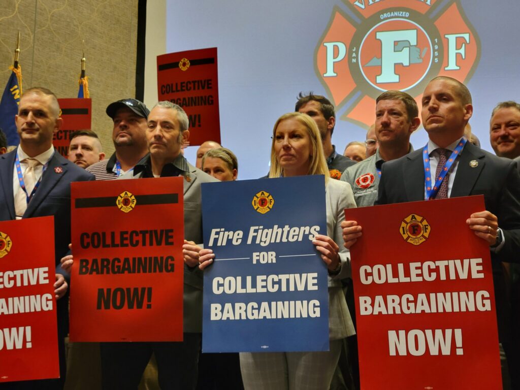 Labor unions are growing, but where depends on state politics 1 Members of Virginia Professional Firefighters association hold signs during their biannual convention in May to protest Democratic Gov. Abigail Spanberger’s veto of collective bargaining legislation. New research found a significant spike in labor union membership, but growth is highly dependent upon state politics. (Photo by Charlotte Rene Woods/Virginia Mercury)